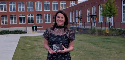Chelsea Newton holding her Best & Brightest 35 and Under award.