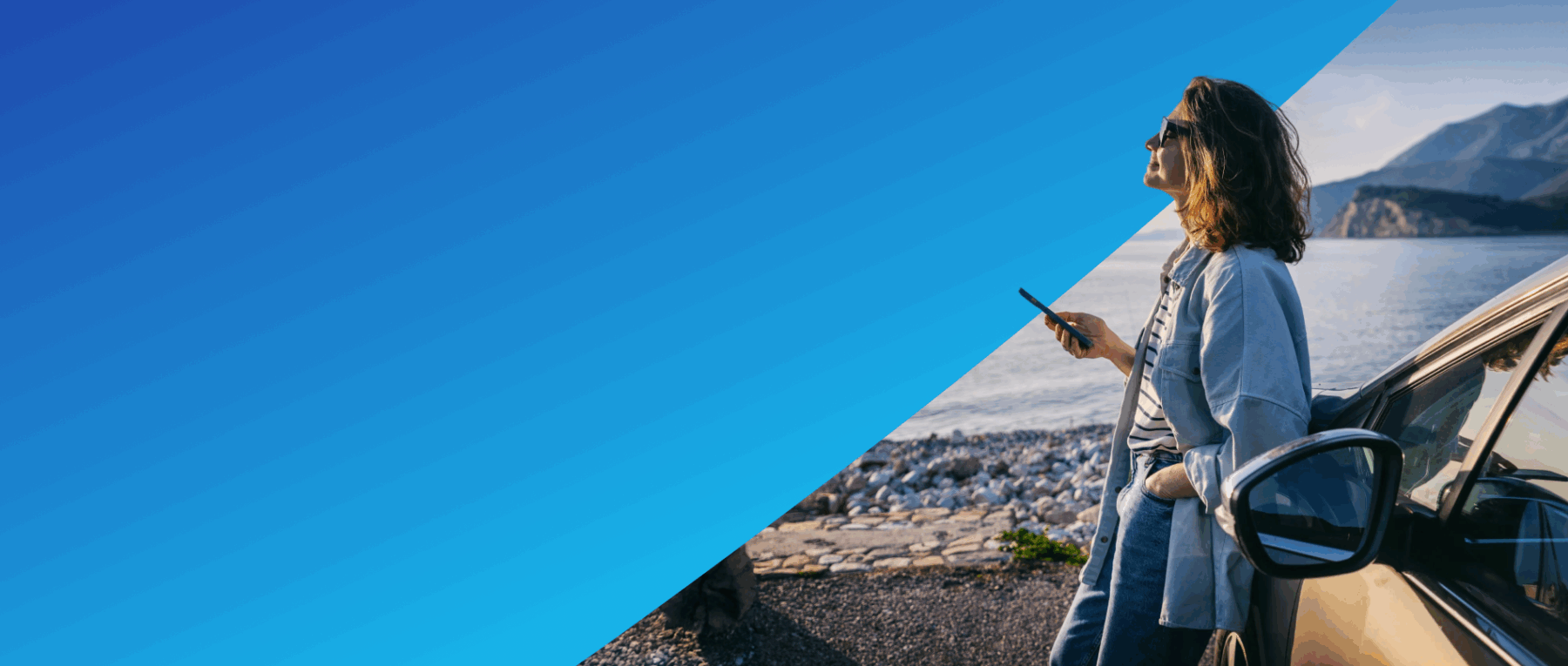 Woman holding a cell phone and leaning against a car.