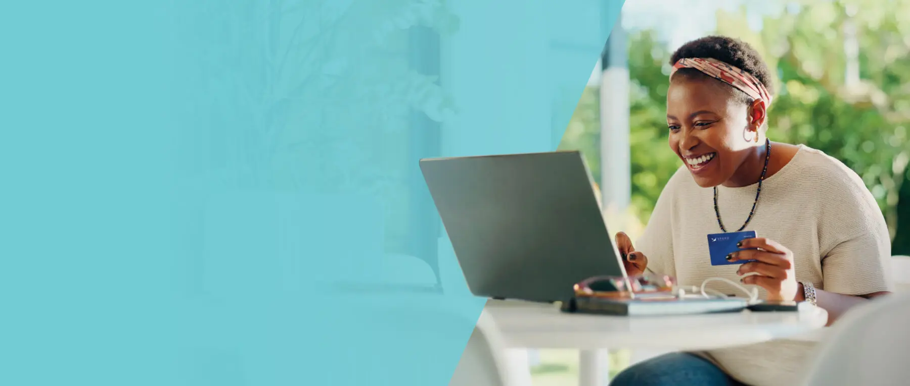 Lady on her computer with Spero debit card