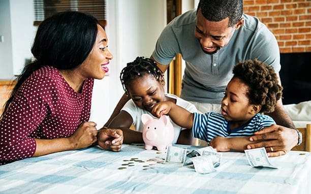 mom and dad helping children count money